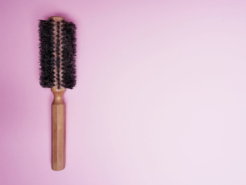 hairbrush on pink background