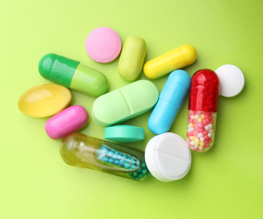 Various pharmaceuticals, pills on green background.