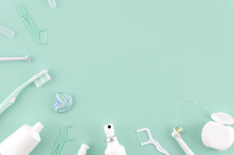 Flat lay composition with manual toothbrushes and oral hygiene products on color background Stomatologist mock up copy space. Teeth care Frame concept