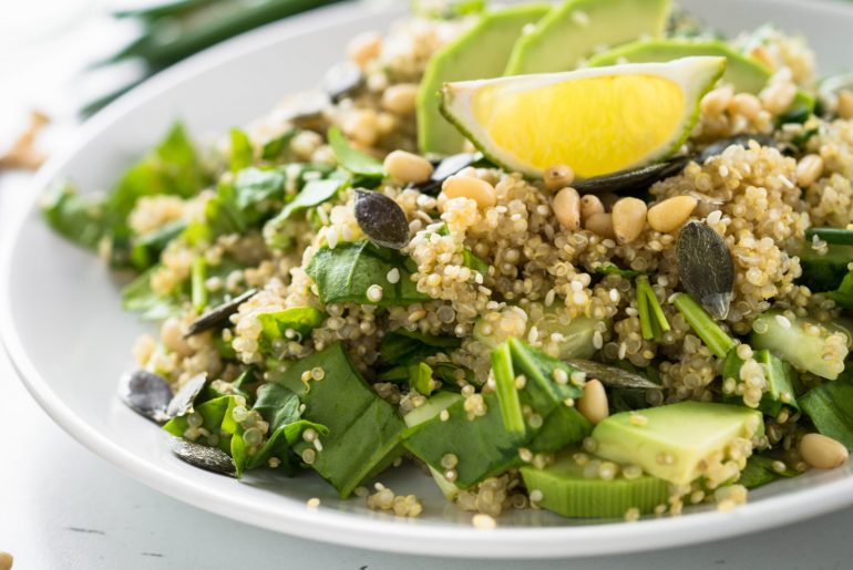 Fresh quinoa salad with spinach, avocado, seeds and Pine nuts. Healthy vegan food.