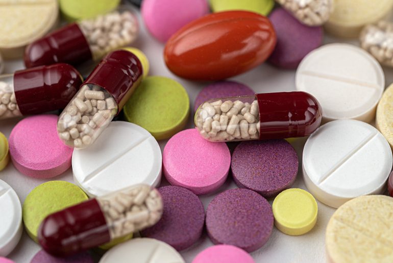 The medicine concept. Multicolored medicines background. Different remedy, pills, capsule, antibiotic and vitamin.