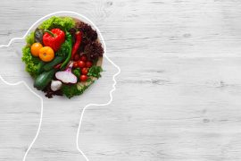 Fresh vegetables in woman head symbolizing health nutrition